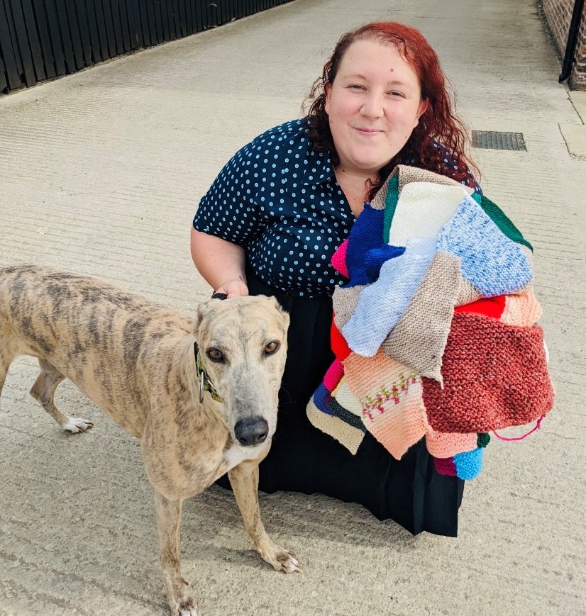 Rebecca the rescue dog receiving her blanket from Annie activities lead at Westfield Park Care Home